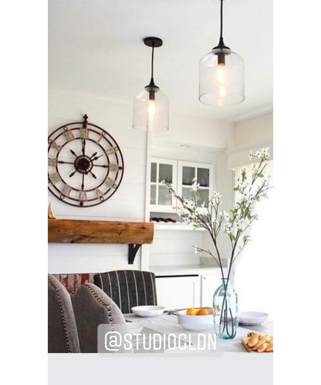 Black metal Jeffery Style Shelf Bracket by Industrial Farm Co supporting rustic wood floating shelf in modern farmhouse ki...
