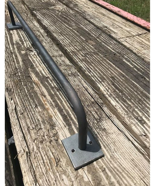 Industrial Farm Co Split Rock Towel Rack in black metal with square mounting plate on weathered wood deck surface