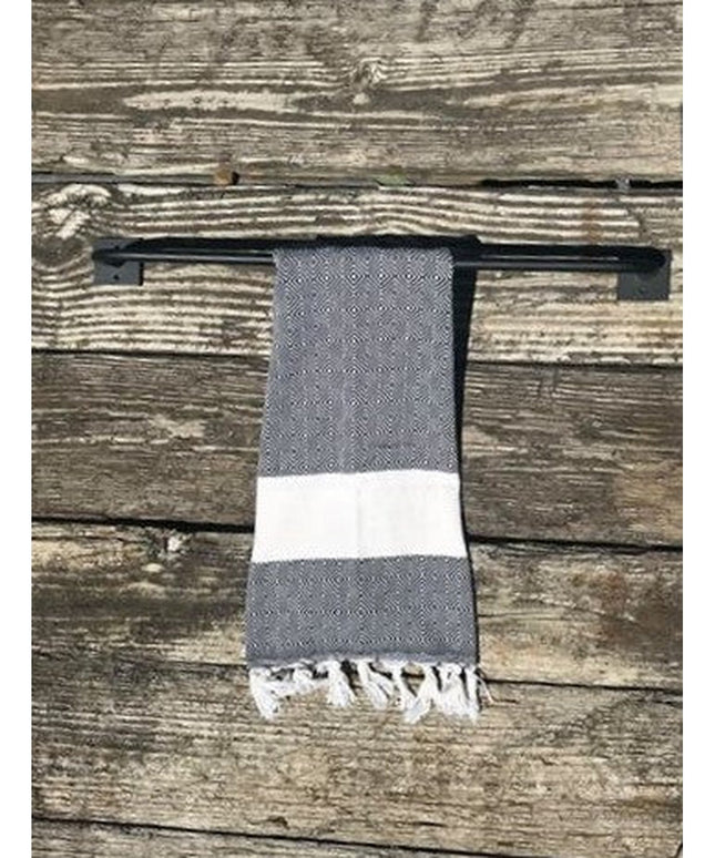 Industrial Farm Co Split Rock black metal towel rack mounted on weathered wood wall with gray and white striped towel