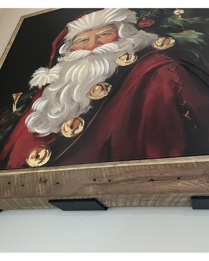 Black steel Lorraine L Shelf Bracket supporting wooden shelf with framed Santa Claus painting, showing heavy duty 4-inch w...