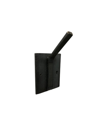 Black metal Tator wall mounted hook by Industrial Farm Co with square mounting plate and cylindrical rod against white bac...