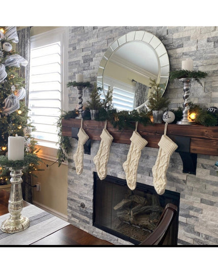 Otisco Farmhouse Style wooden bracket supporting Christmas garland on stone fireplace mantel with cream cable knit stockin...