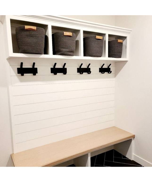 White wooden Fairmount Style Coat Rack by Industrial Farm Co with 4 black hooks, cubby storage baskets, and natural wood b...