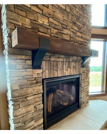 Rustic stone fireplace featuring The Otisco Farmhouse Style Bracket by Industrial Farm Co supporting wooden mantel beam