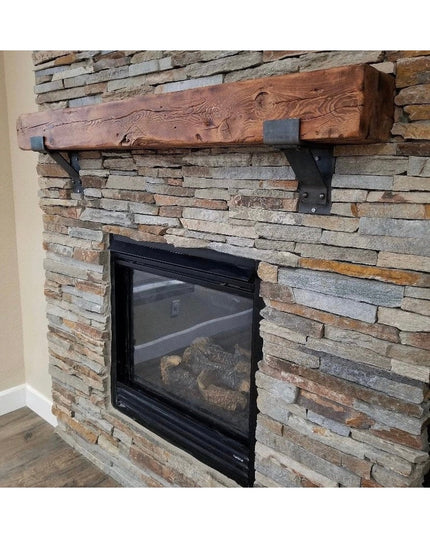 Heavy duty black metal mantel brackets supporting rustic wood beam mantel on stacked stone fireplace - Industrial Farm Co ...