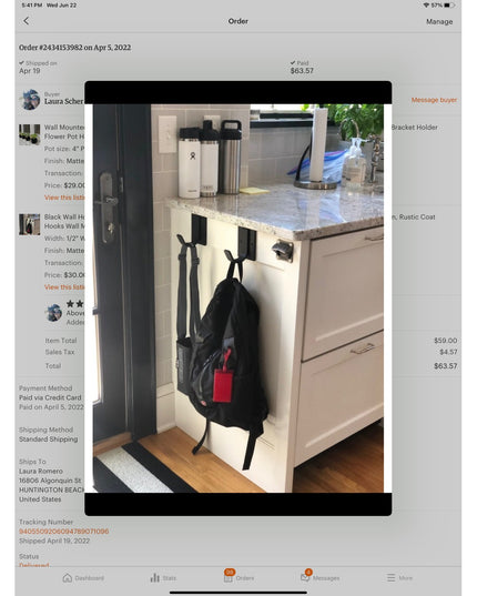 Black metal hooks mounted under kitchen cabinet holding backpack, showing The Dublin Mudroom Hook by Industrial Farm Co in...
