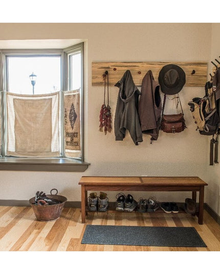 Rustic wooden Eastman Coat & Hook Rack by Industrial Farm Co mounted on entryway wall with coats, hats and bags hanging