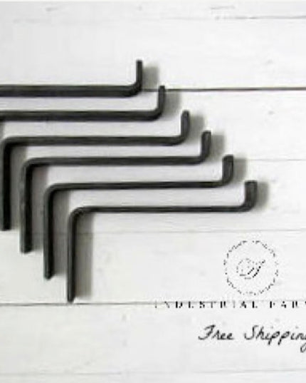 Set of six black metal Z-style shelf brackets by Industrial Farm Co arranged in descending size order on white background