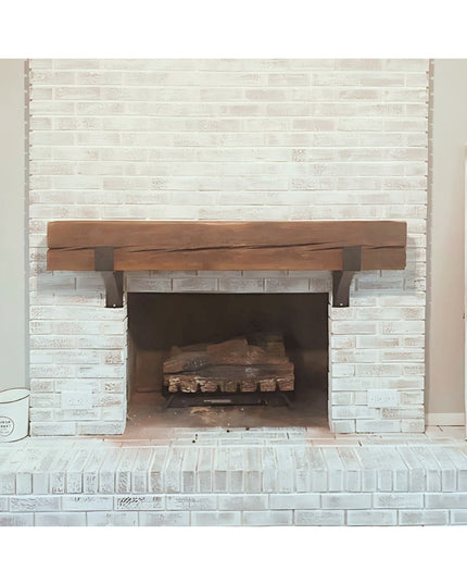Seneca 3" Farmhouse Mantel Bracket in dark metal supporting rustic wood beam mantel on white brick fireplace by Industrial...
