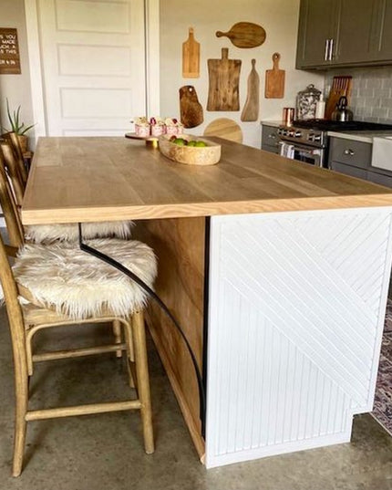 Syracuse Countertop Support brackets from Industrial Farm Co holding wood countertop overhang on white kitchen island with...