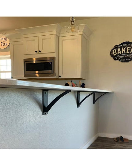 Black metal Lexica 4 inch wide shelf supports by Industrial Farm Co mounted under white floating shelf in modern farmhouse...