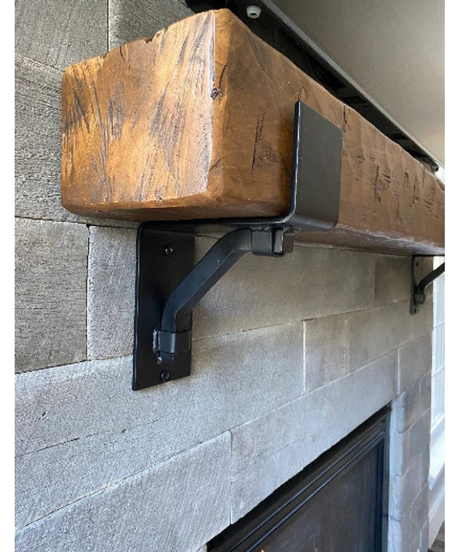 Heavy duty black steel Buffalo mantel bracket with square support bar holding reclaimed wood beam on stone fireplace surro...