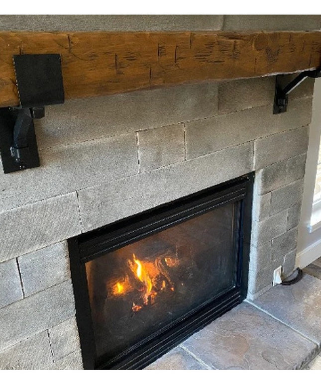Heavy duty black steel mantel brackets supporting rustic wood beam above stone fireplace, The Buffalo 4" Square Support Ba...