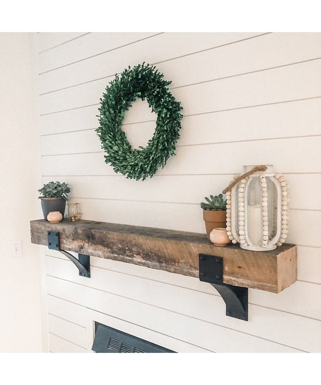 Clermont 4 inch black steel mantel brackets with rivets supporting reclaimed wood beam shelf above white shiplap fireplace...