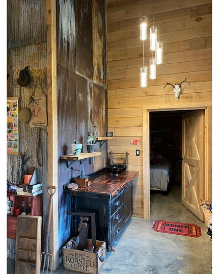 Rustic industrial interior featuring heavy duty steel shelf brackets supporting wooden shelves in barn-style room with cor...