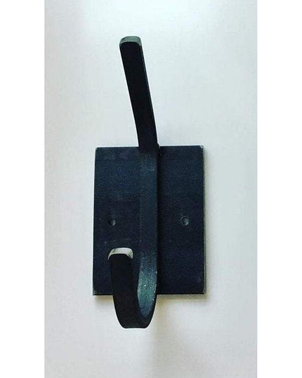 Black metal Felix Wall Hook by Industrial Farm Co mounted on dark wood backing with curved hook design
