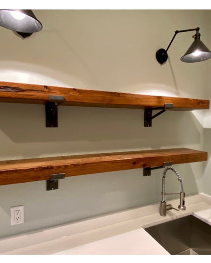 Industrial Farm Co Nauseef black metal shelf support brackets holding two rustic wood shelves above kitchen sink with pend...