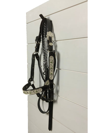 Black leather horse bridle with silver decorative conchos hanging on Industrial Farm Co Tator Wall Mounted Hook against wh...