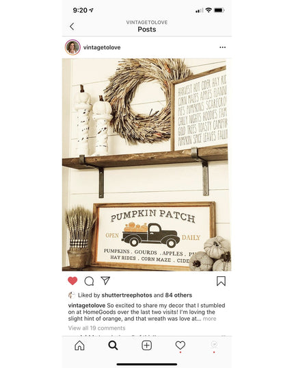 Rustic farmhouse shelf with black metal Z-style brackets supporting wooden shelf displaying fall decor including wheat wre...