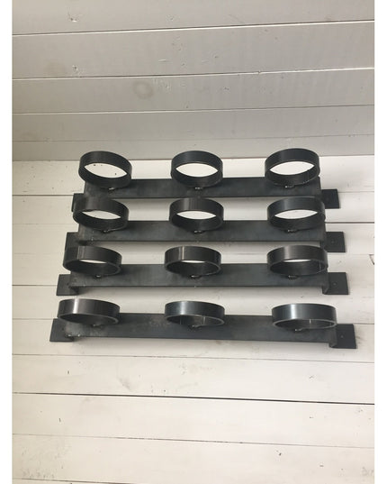 Black steel horizontal wall-mounted planter rack with 12 circular plant holders arranged in 4 rows of 3, The Yonkers by In...