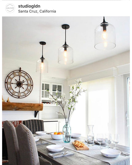 Rustic wooden shelf bracket supporting reclaimed wood floating shelf in modern farmhouse dining room with pendant lights a...
