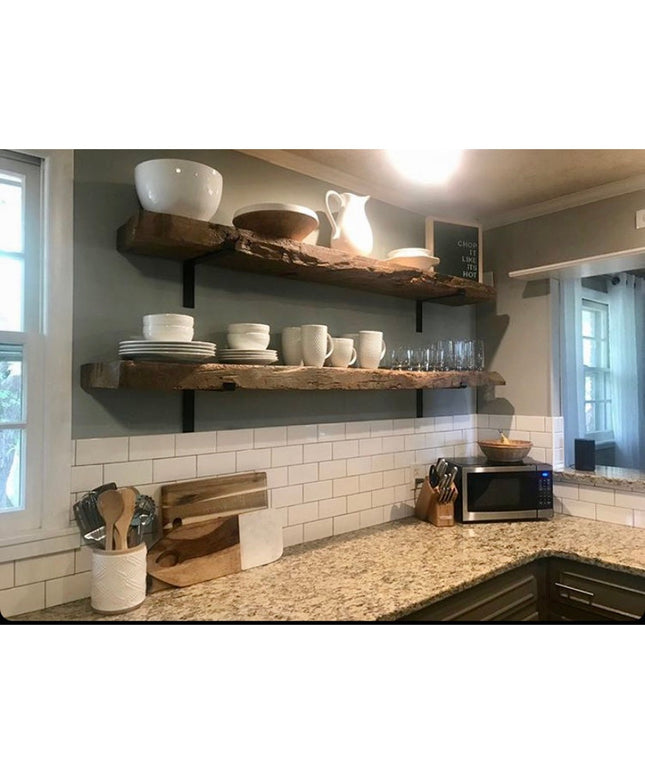 Black metal Z-style shelf brackets supporting rustic wooden shelves with white dishes in modern farmhouse kitchen by Indus...