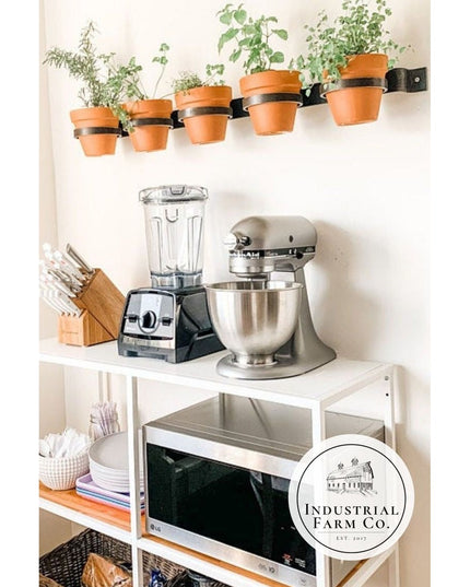 Industrial Farm Co Yonkers horizontal black steel planter rail holding terracotta pots with herbs on white kitchen wall