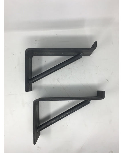 Two black metal triangular shelf brackets from Industrial Farm Co's Shaver Open Shelving Support collection on white surface
