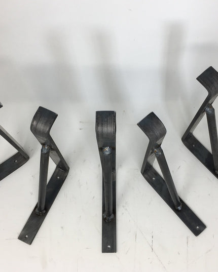 Five black metal Norwich Support Brackets by Industrial Farm Co arranged on white surface, showing adjustable triangular s...