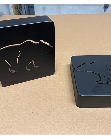 Black metal Vandiver Bear Mantel End Caps by Industrial Farm Co featuring cutout bear silhouettes on dark steel blocks