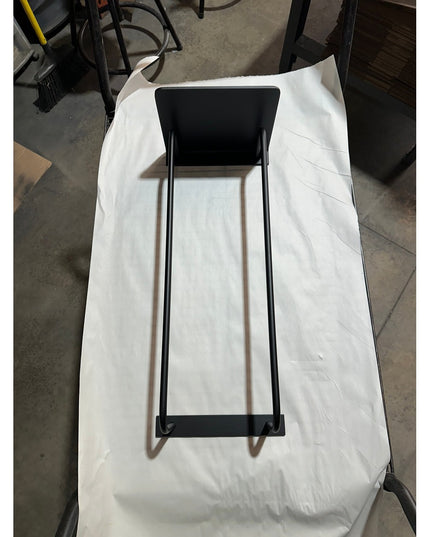 Black metal Diana towel rack with shelf by Industrial Farm Co displayed on white fabric, featuring minimalist industrial d...