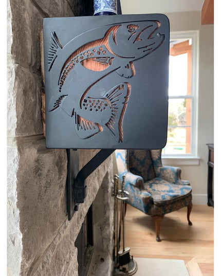 Vandiver Trout Mantel End Caps by Industrial Farm Co in dark gray metal with decorative cutout fish design mounted on ston...