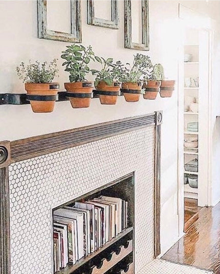 Yonkers Horizontal Steel Planter by Industrial Farm Co mounted on white fireplace mantel holding six terracotta herb pots ...