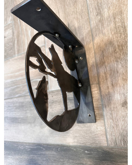 Black metal wolf silhouette shelf bracket by Industrial Farm Co showing handcrafted decorative support on wood surface