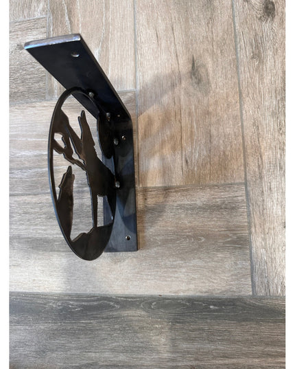 Black metal wolf silhouette shelf bracket mounted on rustic wood wall by Industrial Farm Co - handcrafted decorative support