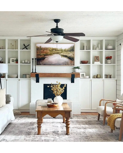Living room with white walls, wooden coffee table, and decorative items.