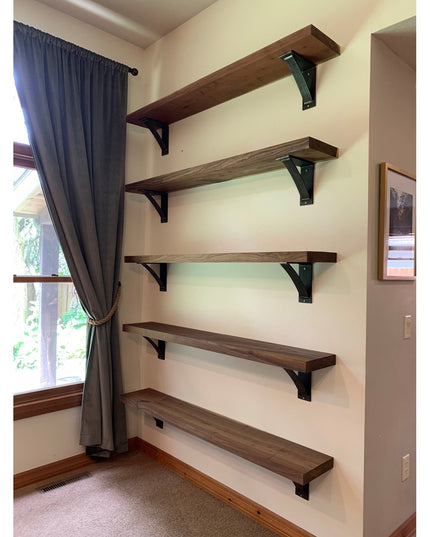 Dark steel Dibbles 3-inch industrial shelf brackets supporting wooden floating shelves on white wall in modern home interior