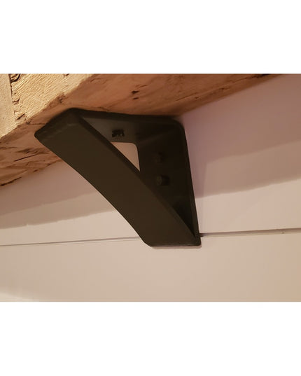 Black steel Eleanor Minimal Steel Bracket by Industrial Farm Co supporting rustic wood beam against white ceiling in moder...