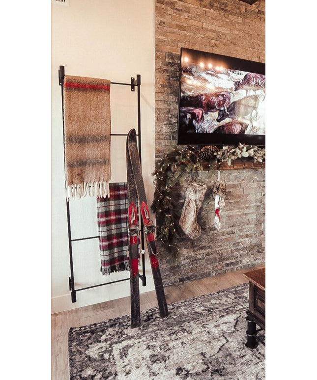Living room with stone fireplace, TV, and Christmas decorations with '#WesternStyle' text.
