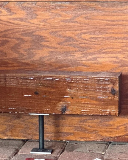 Black metal bar foot rail bracket mounted on rustic wood wall by Industrial Farm Co, showing industrial style hardware for...