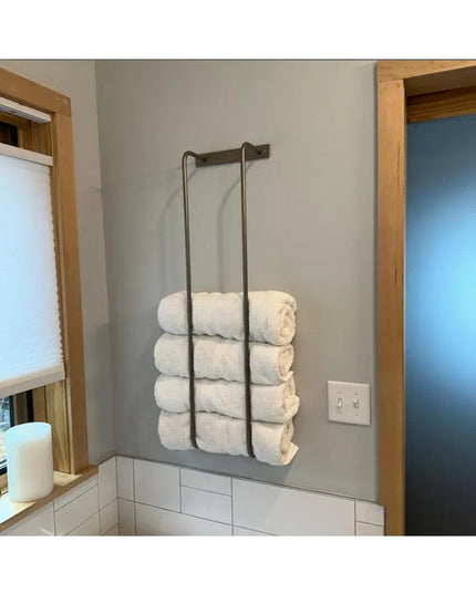 Industrial Farm Co Tyler wall-mounted black metal bathroom towel rack holding rolled white towels in modern bathroom with ...