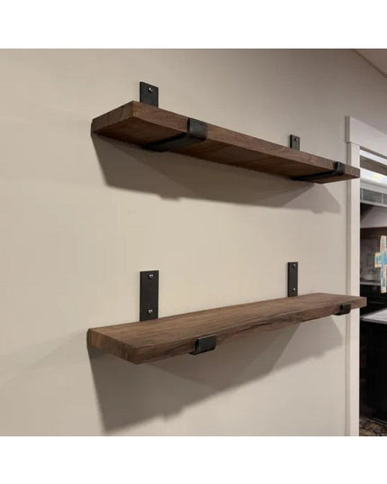 Rustic wooden floating shelves mounted on white wall using black metal Jane J Style Shelf Brackets from Industrial Farm Co