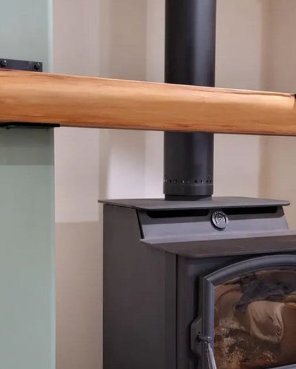 Heavy duty black steel Lorraine L shelf bracket supporting natural wood mantel above modern wood burning stove fireplace