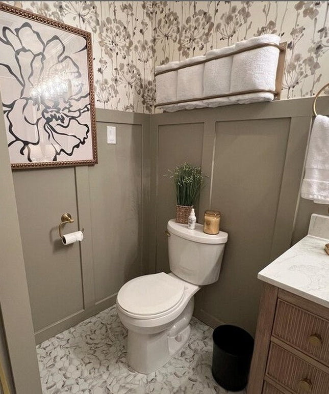 Gold brass Tyler bathroom towel rack mounted on wall in elegant powder room with floral wallpaper and gray wainscoting by ...