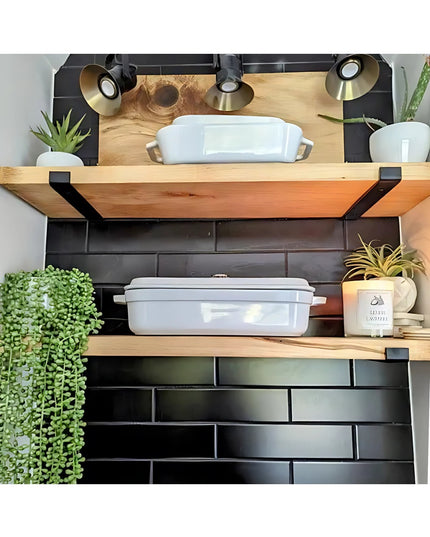 Black metal Earl Style J Shelf Brackets by Industrial Farm Co supporting natural wood floating shelves with white cookware...