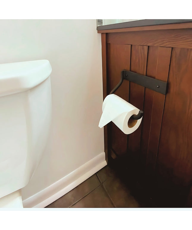 Howlett Hill black metal toilet paper holder mounted on wood cabinet next to white toilet in bathroom by Industrial Farm Co