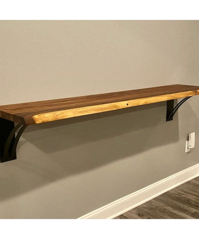 The Little Falls Metal Corbel by Industrial Farm Co supporting a wood shelf, featuring black metal bracket with curved des...