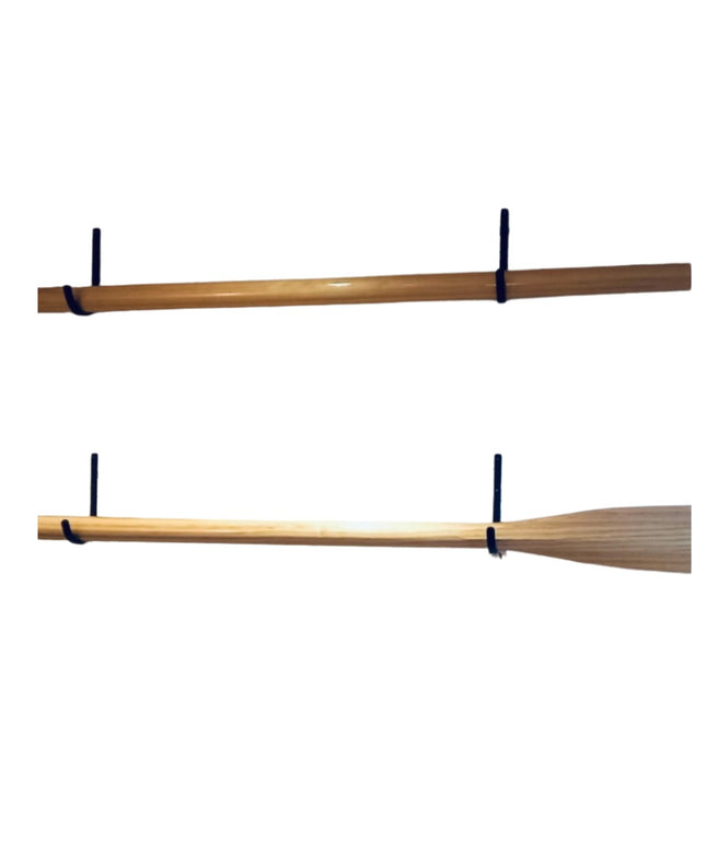 Two wooden oars mounted on black steel display hooks from Industrial Farm Co, showing different oar blade styles against w...