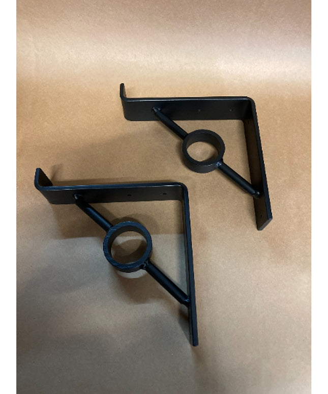 Two black metal Simon Decorative Support Brackets by Industrial Farm Co with triangular design and circular center detail ...