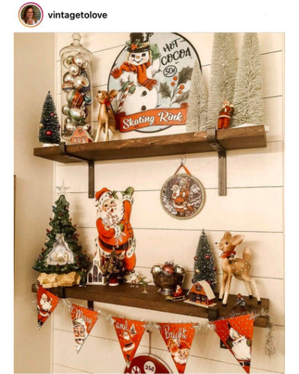 Rustic wooden shelves with black metal Z-style brackets displaying vintage Christmas decorations including snowman sign, r...